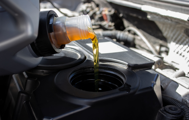 Refueling and pouring oil quality into the engine motor car Transmission and Maintenance Gear . Dodge Oil Change in Mississauga